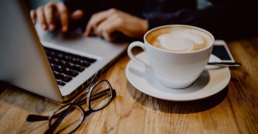 editor at work with coffee and computer